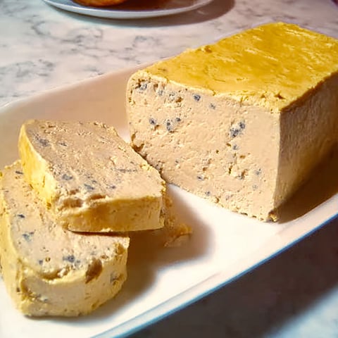 Sur une plaque de verre, une terrine de foie gras signée Joël Robuchon attend d’être partagée.